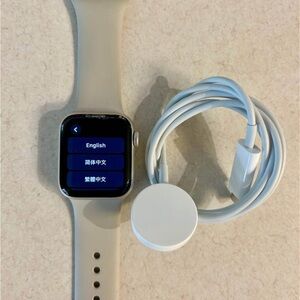 Apple Watch SE with sand color sport band- **has chipped glass**